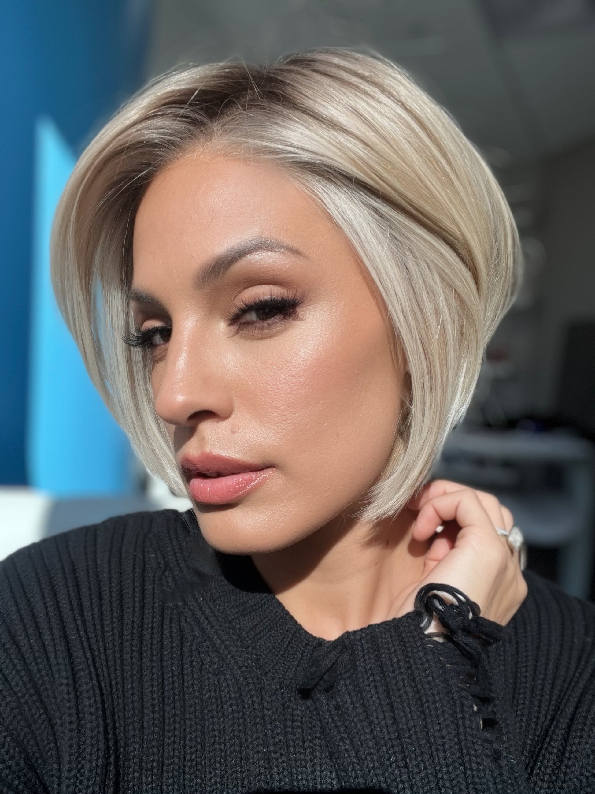 Roxie wearing STRAIGHT UP WITH A TWIST By RAQUEL WELCH in RL19/23SS SHADED BISCUIT | Cool Platinum blonde with subtle highlights and medium brown roots