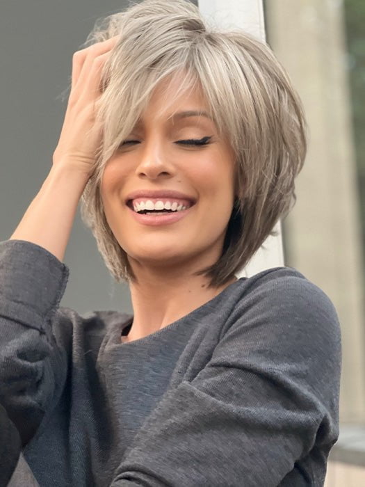 Roxie wearing REESE by NORIKO in SANDY SILVER | Medium Brown Transitionally Blending to Silver and Dramatic Silver Bangs